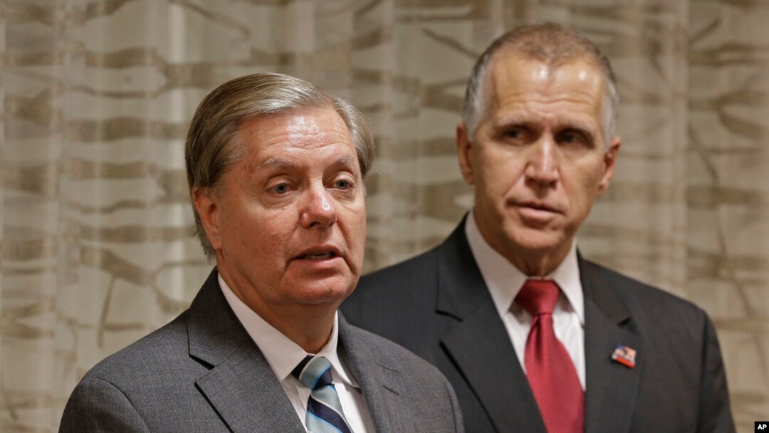 Sen. Lindsey Graham (R-SC), left, speaks to the media about national security as North Carolina Republican Sen. Thom Tillis, right, listens, in Greensboro, N.C., Sept. 26, 2014.