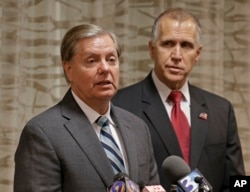 Sen. Lindsey Graham (R-SC), left, speaks to the media about national security as North Carolina Republican Sen. Thom Tillis, right, listens, in Greensboro, N.C., Sept. 26, 2014.