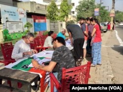 Some voters arrived early Thursday to search for their names on the electoral rolls and beat long lines.