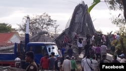 Local authorities and villagers looked for people who were trapped under the building debris after a Buddhist temple under the construction collapsed in Siem Reap, Cambodia, on Dec. 2, 2019. 