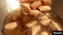 FILE - Stinky tofu is seen fried at the Jiaziyuan Restaurant in New Taipei city.