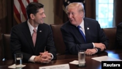 U.S. President Donald Trump talks with House Speaker Paul Ryan (R-WI) as he in the Cabinet Room of the White House in Washington, Nov. 2, 2017.