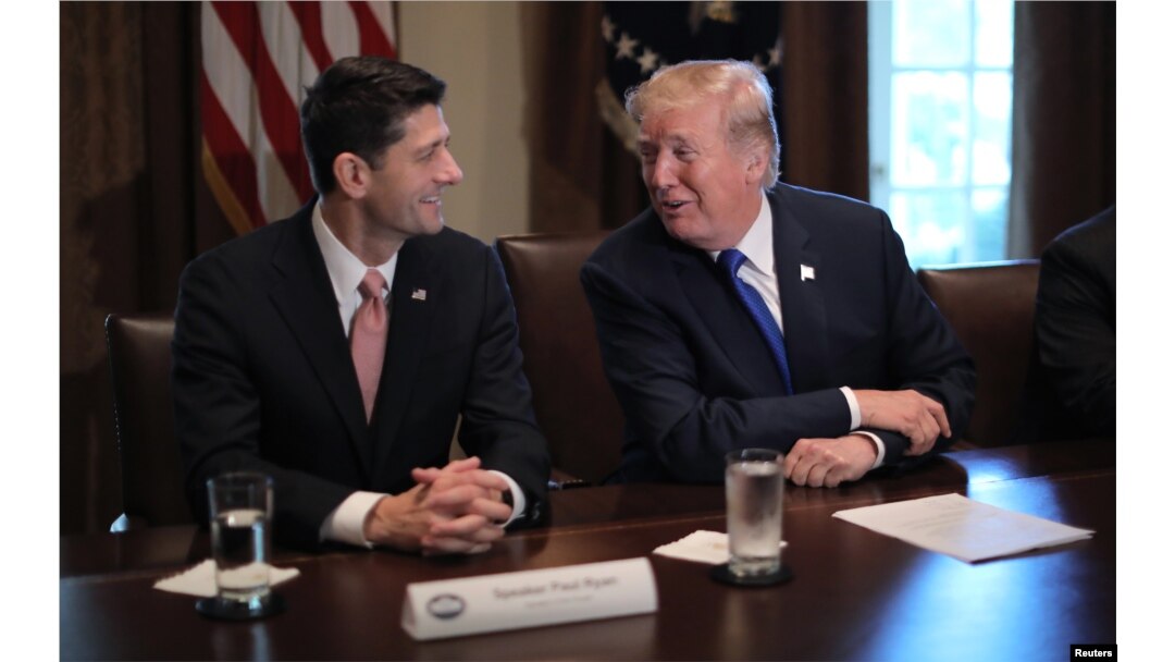 FILE - U.S. President Donald Trump talks with House Speaker Paul Ryan, R-Wis., in the Cabinet Room of the White House in Washington, Nov. 2, 2017.