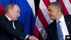 President Barack Obama shakes hands with Russian President Vladimir Putin, G20 Summit, Los Cabos, Mexico, June 18, 2012.