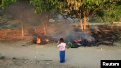 Unidentified man photographs bodies burning in the wake of sectarian riots in Meikhtila, Burma, March 22, 2013.