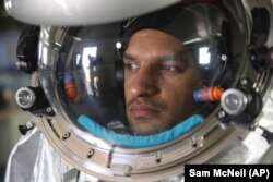 Analog astronaut Kartik Kumar wears an experimental space suit during a simulation of a future Mars mission in the Dhofar desert of southern Oman.