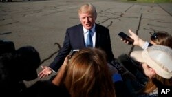 President Donald Trump speaks with reporters before boarding Air Force One at Morristown Municipal airport, Sept. 24, 2017, in Morristown, N.J. 