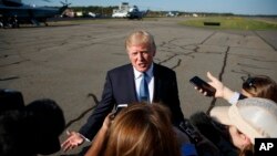 President Donald Trump speaks with reporters before boarding Air Force One at Morristown Municipal airport, Sept. 24, 2017, in Morristown, N.J. 