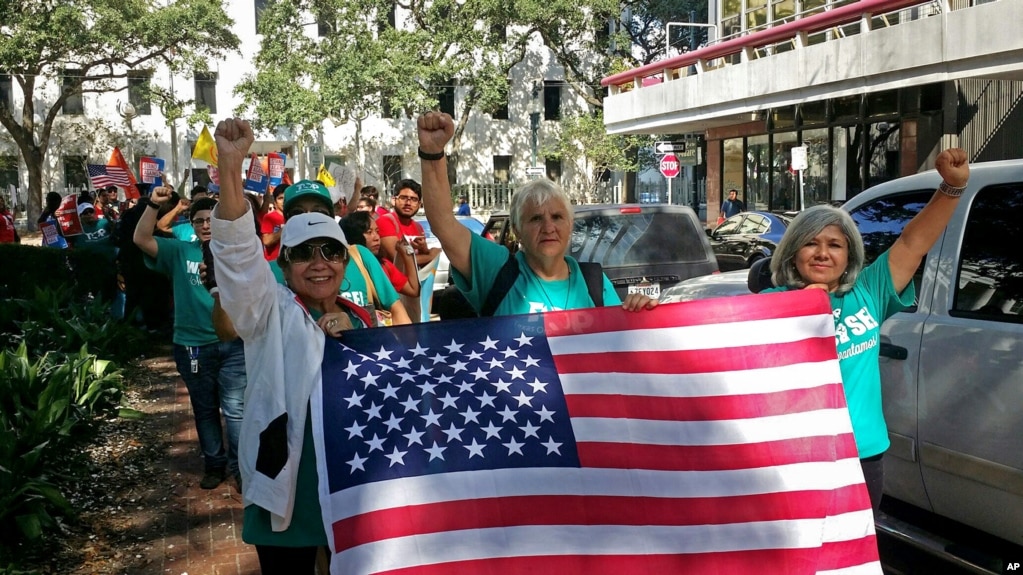 FILE - Demonstrators march outside federal court in New Orleans, Sept. 22, 2017, with immigrants and their advocates chanting and beating drums to protest immigration laws.