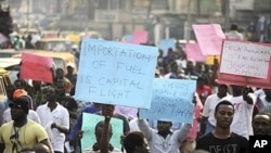 Protesters hold placards, shout slogans on Ikorodu road in Nigeria's commercial capital, Lagos, January 3, 2012.
