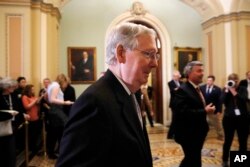Senate Majority Leader Mitch McConnell of Kentucky leaves a news conference with Republican leaders, March 20, 2018, on Capitol Hill in Washington.
