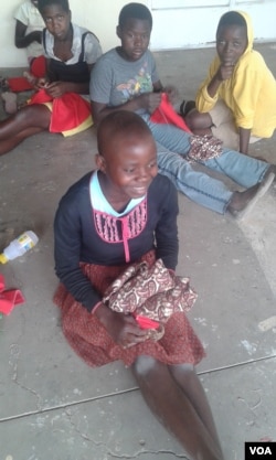 Zimbabwean girls smile after making their own sanitary pads. They can hardly get money to buys pads. (VOA)