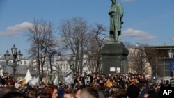 People gather outside Alexander Pushkin monument in downtown Moscow, March 26, 2017.