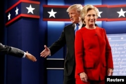 Republican U.S. presidential nominee Donald Trump and Democratic U.S. presidential nominee Hillary Clinton take the stage for their first debate in Hempstead, New York, U.S. September 26, 2016.
