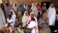 In this April 2011 file photo, Muslim women wait to cast their vote at a polling place in Daura, Nigeria. A new study projects that population growth in Africa is a factor in the growth of Islam.