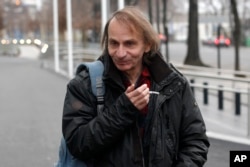 FILE - French novelist Michel Houellebecq after an interview on radio station France Inter, in Paris.