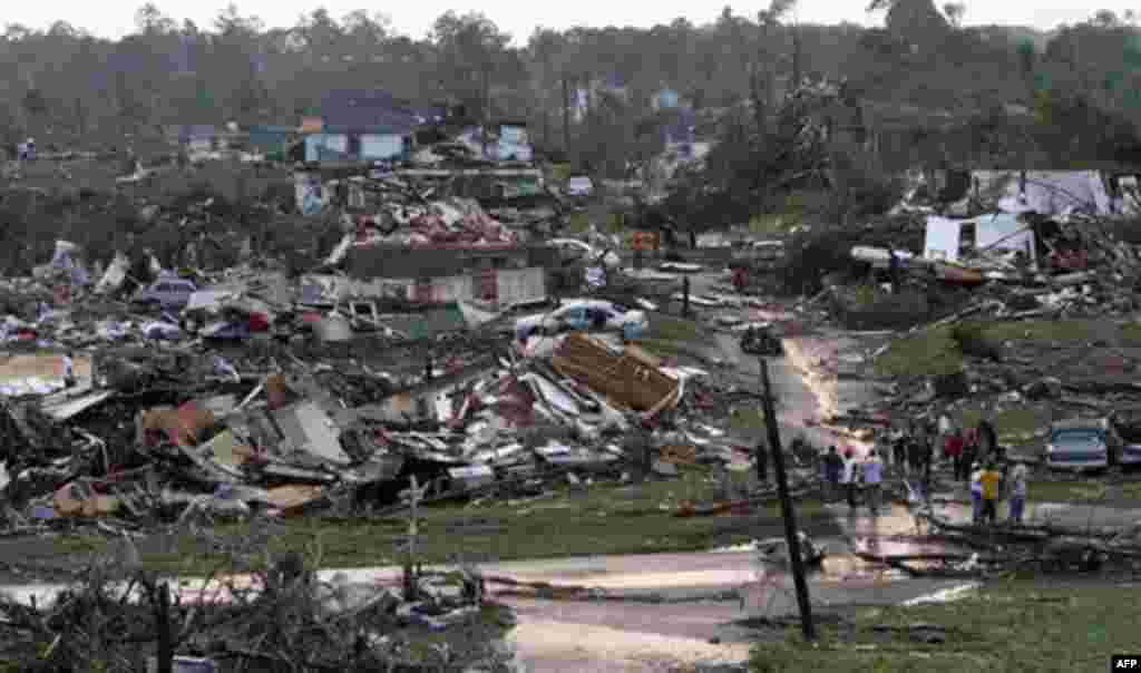 Residents survey the destruction after a tornado hit Pratt City, Ala. just north of downtown Birmingham, Ala. on Wednesday, April 27, 2011. A wave of severe storms laced with tornadoes strafed the South on Wednesday, killing at least 16 people around the 