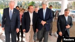 Prime minister Nawaz Sharif, second from left, walks along with then-U.S. Senators John Kerry, Joseph Biden, Chuck Hegel and his party president Shahbaz Sharif, Lahore, Feb 18, 2008 file photo.