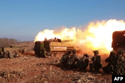 FILE - A firing contest of Korean People's Army artillery units, which North Korean leader Kim Jong Un inspected, at an undisclosed location in North Korea, Jan. 15, 2015.