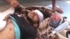 Citizen journalism image made from video provided by Shaam News Network SNN, purports to show a victim wounded by violence that, according to anti-regime activists, was carried out by government forces in Tremseh, Syria, July 12, 2012