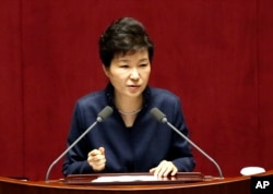 FILE - South Korean President Park Geun-hye delivers a speech at the National Assembly in Seoul.