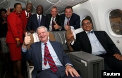 U.S. Under Secretary of Commerce Gilbert Kaplan poses for a picture alongside Kenya's Tourism Minister Najib Balala inside a Kenya Airways Boeing Dreamliner 787-8 at the Kenya Airways headquarters in Nairobi, June 27, 2018. With them are Kenya Airways staff, Kenya's Transport Minister James Macharia, U.S. Ambassador to Kenya Robert Godec and Kenya Airways Chief Executive Officer Sebastian Mikosz.