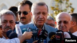 Turkey's President Tayyip Erdogan talks to media after the Eid al-Fitr prayers in Istanbul, June 25, 2017.