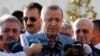 Turkey's President Tayyip Erdogan talks to media after the Eid al-Fitr prayers in Istanbul, June 25, 2017.