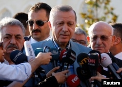 Turkey's President Tayyip Erdogan talks to media after the Eid al-Fitr prayers in Istanbul, June 25, 2017.