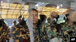 Members of Bangladesh Rifles (BDR) who are accused of a mutiny wait to be brought back to jail after a hearing before a special court in Dhaka on July 12, 2010