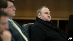 FILE - Kim Dotcom sits in the Auckland District Court during an extradition hearing in Auckland, New Zealand.