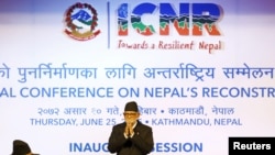 Nepal's Prime Minister Sushil Koirala greets upon his arrival to take part in the International Conference of Nepal Reconstruction in Kathmandu, June 25, 2015. 