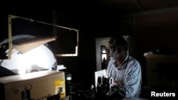 Devendran, a 55-year-old observer, works inside the solar tunnel telescope at the Kodaikanal Solar Observatory, India, Feb. 5, 2017.