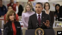 President Barack Obama, accompanied by American Red Cross President and CEO Gail J. McGovern, gestures while speaking during his visit to discuss superstorm Sandy, at the Disaster Operation Center of the Red Cross National Headquarters in Washington, Oct.