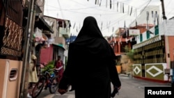 A Muslim woman wearing a hijab walks through a street near St. Anthony's Shrine, days after a string of suicide bomb attacks across the island on Easter Sunday, in Colombo, Sri Lanka, April 29, 2019.