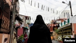 A Muslim woman wearing a hijab walks through a street near St Anthony's Shrine, days after a string of suicide bomb attacks across the island on Easter Sunday, in Colombo, Sri Lanka, April 29, 2019.