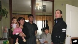 Russian President Dmitry Medvedev, right, visits an unidentified Russian family in the town of Yuzhnokurilsk, at the Pacific Island of Kunashir, Russia, 01 Nov 2010