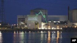 This Greenpeace photo shows a video projection reading "Tricastin, nuclear accident, " on the Tricastin power plant complex, July 15, 2013 in southern France. 