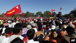 Supporters gather to hear speech delivered by Myanmar opposition leader Aung San Suu Kyi at a ceremony marking the National Day in Natmauk township, Magwe division, native land of her late father General Aung San, Myanmar, Saturday, Dec. 8, 2012. (AP Pho