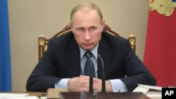 FILE - Russian President Vladimir Putin listens during meeting at the Kremlin, Moscow, May 27, 2015.