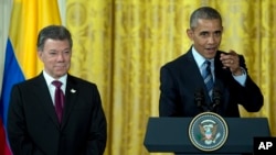 President Barack Obama, joined by Colombian President Juan Manuel Santos, speaks at a reception for Plan Colombia, the joint effort to create a safer, more prosperous future for Colombians, in the East Room of the White House, in Washington, Thursday, Feb. 4, 2016. (AP Photo/Carolyn Kaster)