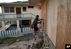 Kaipo Popa secures plywood to protect windows on a home in preparation for Hurricane Lane, Aug. 22, 2018, in Kapolei, Hawaii.