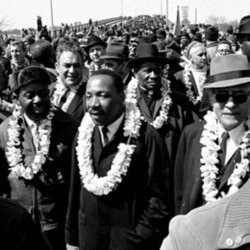 Martin Luther King Jr. leads a march to Alabama's capital, Montgomery, to protest unfair voting laws