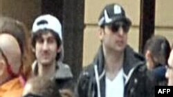  Images released by Federal Bureau of Investigation (FBI) shows "Suspect 2" (L-white cap) and "Suspect 1" (R-black cap) in the crowd before the blast at the Boston Marathon on April 15, 2013.