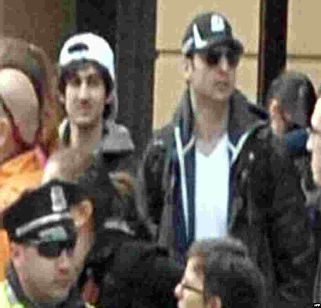  Images released by Federal Bureau of Investigation (FBI) shows "Suspect 2" (L-white cap) and "Suspect 1" (R-black cap) in the crowd before the blast at the Boston Marathon on April 15, 2013.