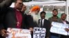 People hold signs for the victims who were killed during a fatal attack on the Bethel Memorial Methodist Church in Quetta, during a protest in Karachi, Pakistan, Dec. 18, 2017. 