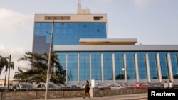 FILE - Pedestrians walk in front of Ghana's central bank building in Accra, Ghana, Nov. 16, 2015. 