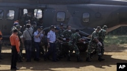 Indonesian soldiers carry a victim of Wednesday's plane crash at Cijeruk in Bogor, West Java, Indonesia, Saturday, May 12, 2012.