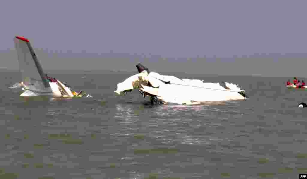 Bangladesh rescuers gather around the wreckage of a cargo plane that crashed into the Bay of Bengal minutes after taking off from the southeastern resort town of Cox&#39;s Bazar, killing three Ukrainian crew members and critically injuring one more, officials said.