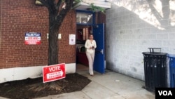 Juline Kaleyias, 30, an Arlington County resident walks out after voting during a primary election at a polling station inside the Francis Scott Key Elementary School in Arlington, Va., June 12, 2018. She knew that Chanda lacked political experience but said she liked his immigrant and military backgrounds.(Sophat Soeung/VOA Khmer)